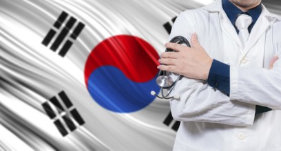 Doctor with stethoscope on South Korean flag. Doctor with crossed arms on South Korean flag.