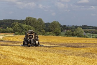 Burnt-out combine harvester, Steinbergkirche, Schleswig-Holstein, Germany, Europe