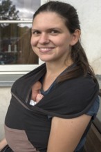 Young mother with baby in sling, Mecklenburg-Western Pomerania, Germany, Europe