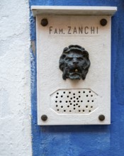 Name and doorbell button in the shape of a lion on a blue house wall, Burano Island, Venice,