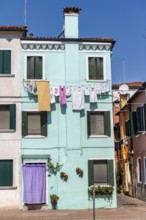 Colourful houses with clothesline, colourful house facades, alleys on the island of Burano, Venice,