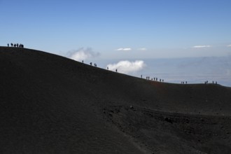 Hikers in the crater landscape of the volcano Etna, summit region, province of Catania, Sicily,