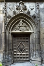 Chateaugay. Carved door in the courtyard of the castle. Puy de Dome department. Auvergne Rhone