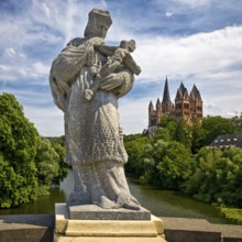 Statue of the bridge saint Nepomuk on the Old Lahn Bridge with Limburg Cathedral St. George,