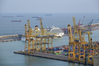 BARCELONA, SPAIN, APRIL 15, 2019: Aerial view of Barcelona port with harbour cranes and ruise ship.