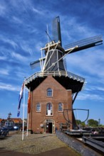 HAARLEM, NETHERLANDS, MAY 6, 2017: Windmill De Adriaan on Spaarne river. Harlem, Netherlands. The