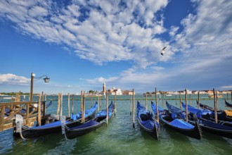 Gondolas and in lagoon of Venice by Saint Mark (San Marco) square with San Giorgio di Maggiore