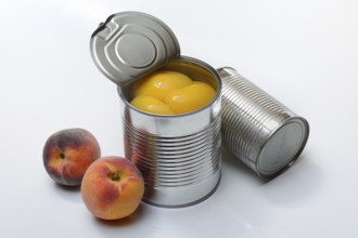 Peach, preserved peach halves with syrup in a tin can