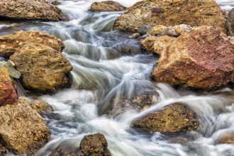 Water flowing, river between boulders, long exposure, illustration, Almeria, Andalucia, Spain,