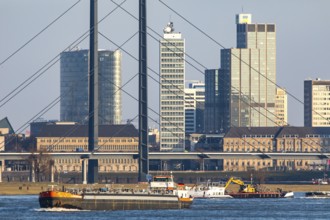 Düsseldorf, city centre skyline, skyscrapers, Rheinkniebrücke, Rhine, cargo ship