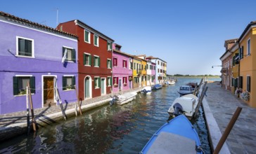 Colourful houses on the canal, canal with boats and colourful house facades, Burano Island, Venice,