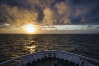 View from the ferry King Seaways of an atmospheric sunset with dramatic clouds over the North Sea,