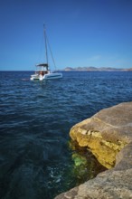 Yacht boat in Aegean sea at white rocks of Sarakiniko Beach, Milos island, Greece, Europe