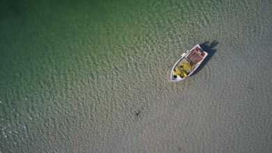 Drone shot, green lagoon, fishing boat directly from above, Gramvoussa peninsula, Pirate Bay,