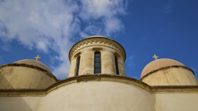 Towers with cross, round tower, ochre building, wide angle, blue sky with white clouds, Odigitrias