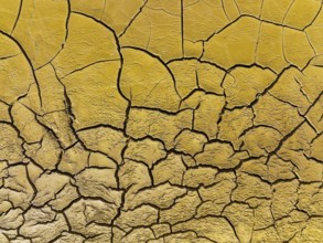 Mineral-rich cracked earth at the bank of the Rio Tinto (Red river), aerial view, drone shot,