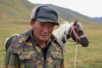 Shepherd with his horse, West Karakol Valley, Tien Shan Mountains, Naryn Region, Kyrgyzstan, Asia