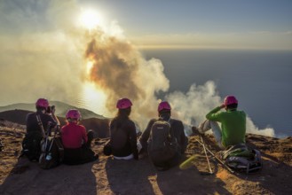 Tourists at the crater edge of the smoking layer volcano Stromboli, island Stromboli, Liparian