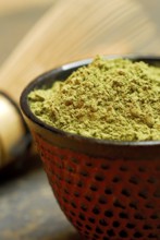 Japanese Matcha tea, bamboo broom, bowl with green tea powder, green tea