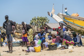 Fishermen's wives with fishing boats on the beach of Sanyang, Gambia, West Africa, Africa