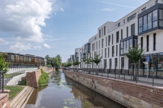 New residential buildings by the river Queich, on the left the municipal library on the former