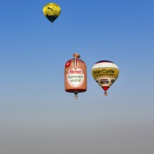 Three hot-air balloons travelling in the blue sky, advertising for Reinert Sommerwurst, BVB, Brian