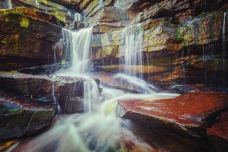 Vintage retro effect filtered hipster style image of tropical waterfall. Popokvil Waterfall, Bokor