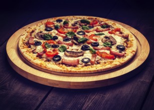 Vintage retro effect filtered hipster style image of ham pizza with (capsicum), mushrooms, olives