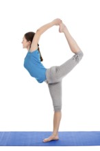 Yoga, young beautiful slender woman yoga instructor doing Lord of the Dance Pose (Natarajasana)