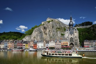 DINANT, BELIGUM, MAY 30, 2018: View of Dinant city over the Meuse river with tourist boat. Dinant