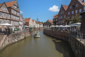 Historic merchant and warehouse houses at the Hanseatic harbour with the sailing ship Willi, Old