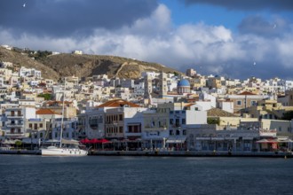 View of the town of Ermoupoli with pastel-coloured houses and sea, waterfront promenade with