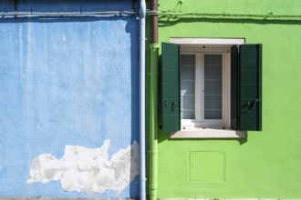 Blue and green house facade with window, colourful houses on the island of Burano, Venice, Veneto,