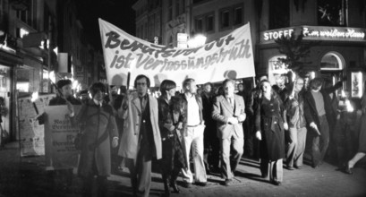 Nazi victims, some in concentration camp uniforms, demonstrated against the occupational bans