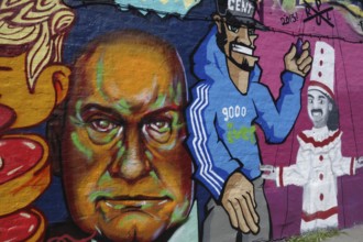 Colourful graffiti on wall in alley showing the mayor of Ghent, Daniel Termont, and Pierke