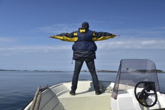 Senior, man on a motorboat on the Atlantic Road in Norway