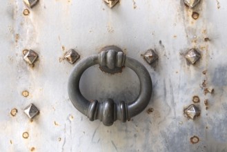 Door knocker on an iron door, Genoa, Italy, Europe