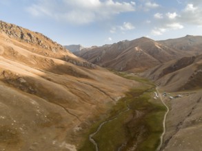 Aerial view of mountain valley with gravel road, Naryn region, Kyrgyzstan, Asia