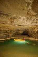 Karst cave, lake, rubber dinghy, speleologist, Krizna jama, Cerknica, Carniola, Slovenia, Europe