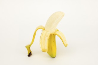 Half peeled banana, studio shot, white background, healthy diet