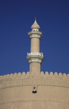 Mosque tower and parapet of the old fort of Nizwa. Nizwa is the centre of the Omani heartland. The