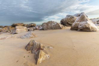 Rocks polished by waves of Atlantic Ocean on sandy beach. Sables d'olonne, France, Europe