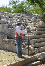 Surveyor at work, Temple of Panels, Templo de los Tableros Esculpidos, Chichen Itzá, Mayan ruins,