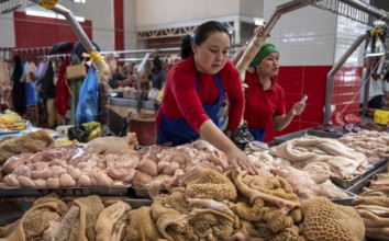 Woman selling meat and entrails, butcher's shop with fresh meat, market at Osh bazaar, Bishkek,