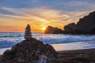 Concept of balance and harmony. Cairn stack of stones pebbles cairn on the beach coast of the sea