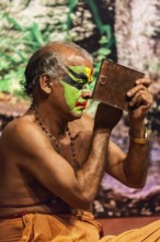 KOCHI, INDIA, FEBRUARY 24, 2013: Unidentified Kathakali exponent preparing for performance by