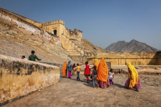 AMER, INDIA, NOVEMBER 18, 2012: Visitors (women in Rajasthani attire) going to Amer (Amber) fort.