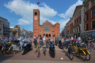 Amsterdam, Netherlands, May 7, 2017: Beursplein with parked bicycles and motorcycles and Beurs van