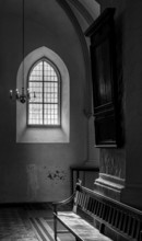 Black and white, window and wooden bench in St. Mary's Church at Alexanderplatz, Berlin, Germany,