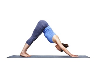 Beautiful sporty fit yogini woman practices yoga asana adhomukha svanasana, downward facing dog